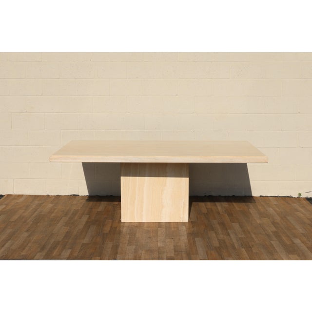 Striking Mid-Century Modern Italian dining table crafted from beautiful natural travertine stone, dating to the 1970s....