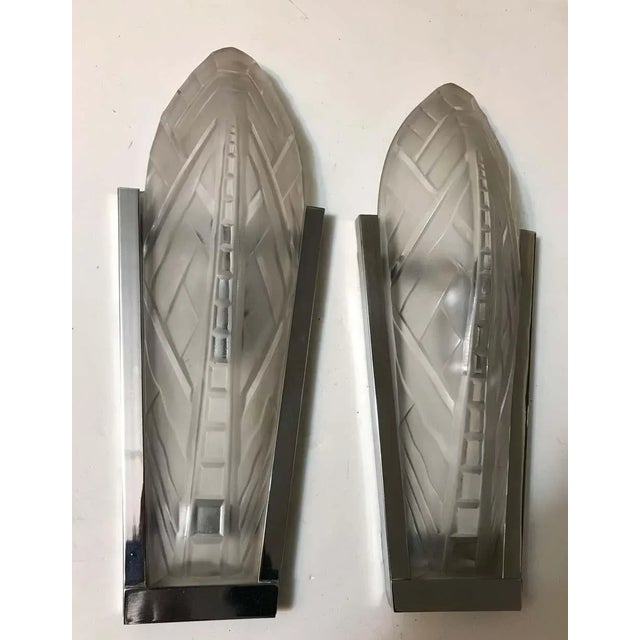 A stunning pair of French Art Deco wall sconces signed by famous French artist Sabino. Clear and frosted molded glass...