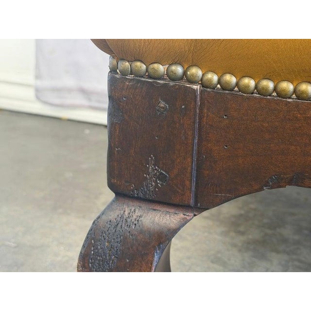 A sophisticated vintage Chesterfield tufted ottoman bench, a quintessential piece of timeless luxury and enduring style....