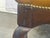 A sophisticated vintage Chesterfield tufted ottoman bench, a quintessential piece of timeless luxury and enduring style....