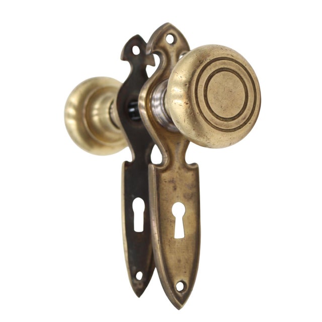 Traditional style passage door knob set made of brass door knobs and steel back plates. Priced as two door knobs, two back...