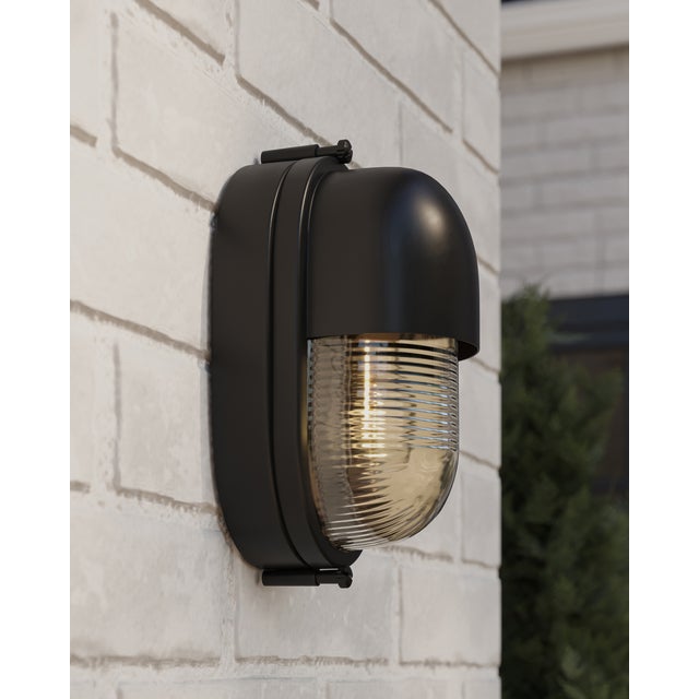 The Maritime Black Outdoor Wall Sconce has its sea legs, so to speak, given it has the quintessential design attributes...