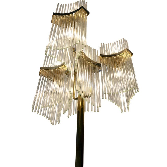 Pair of Italian floor lamps designed by Gaetano Sciolari in 1970's. The base is in brass decorated with glass stripes that...