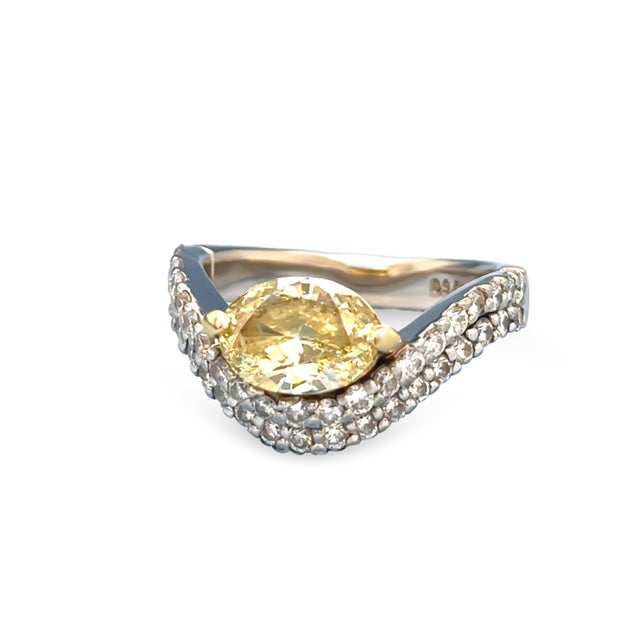 An Argyle Diamond 18ct White gold and Yellow gold set ladies diamond ring. The ring features a central Marquise cut fancy...