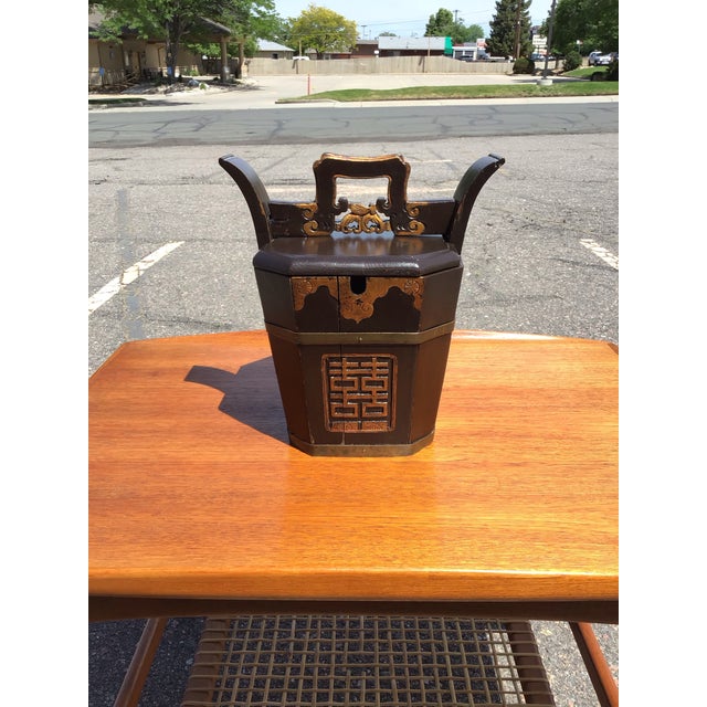 A finely crafted antique Chinese teapot caddy featuring an elegant blend of traditional form and decorative symbolism....