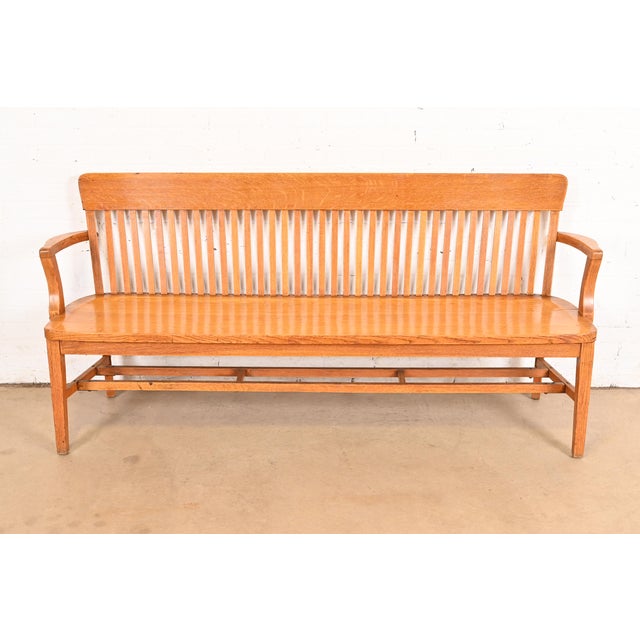 An exceptional antique Arts & Crafts solid oak spindle back banker or lawyer bench USA, Early 20th Century Measures:...