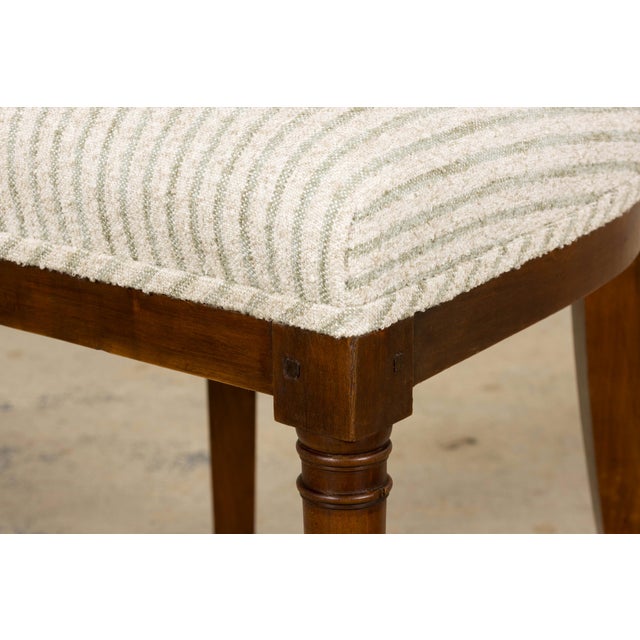 Sourced in Provence, France, this set of eight French Directoire walnut dining chairs showcases the restrained elegance...