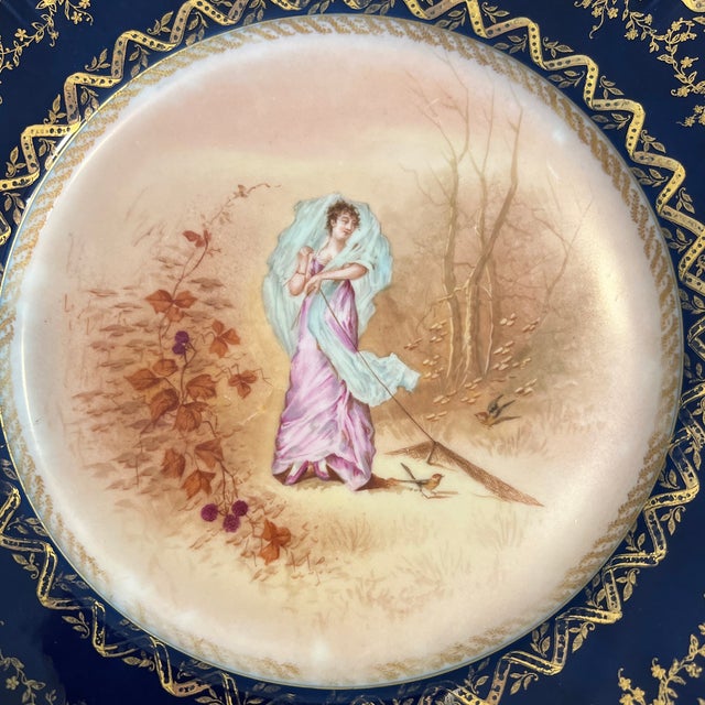 Truly an amazing find! Intricately handpainted Limoges cabinet plate in a background with a cobalt band encrusted with a...