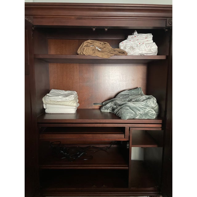Ethan Allen British Classics wood armoire, Made in America, featuring paneled bi-fold doors, fluted detailing, classic bun...