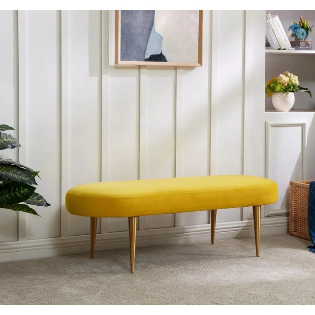 Add a touch of elegant glamour to any modern décor with this marigold velvet oval bench. Its retro gold legs and chic...