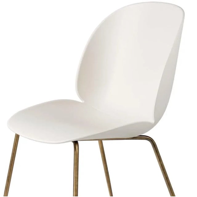 GamFratesi 'Beetle' dining chair with brass conic base. Designed by Danish-Italian design-duo GamFratesi in 2013. The...