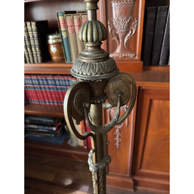 A striking antique floor lamp sourced from Paris, crafted in richly patinated bronze and imbued with refined neoclassical...