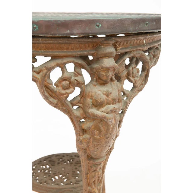 This English Pub Table features a copper top and a sturdy cast iron base, giving it an antique charm. The round tabletop...