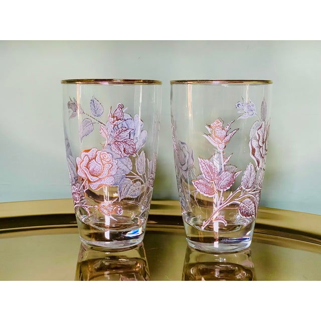 A pair of white and gold rose patterned tumblers made by the Libbey Glass Company. Glasses measure 5 1/4 inches tall, 2...