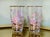 A pair of white and gold rose patterned tumblers made by the Libbey Glass Company. Glasses measure 5 1/4 inches tall, 2...