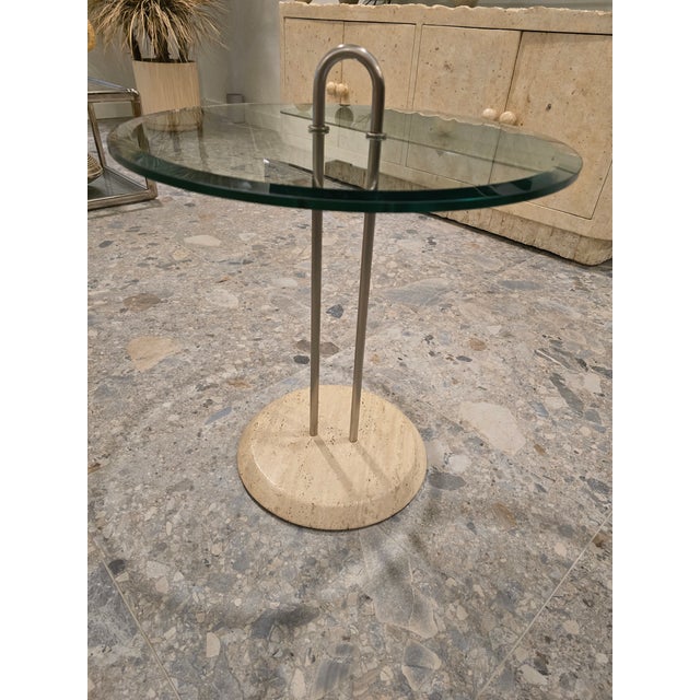 Timeless side table by Vico Magistretti. Elegant and sophisticated Hollywood Regency style with a beige/ tan travertine...