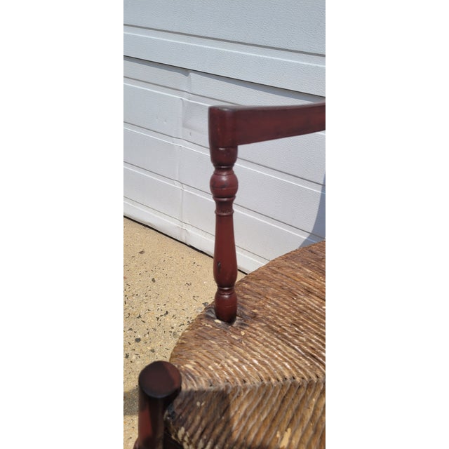 Find vintage country French bench in red paint. Featuring wide rush seat, turned carved stretcher, splayed arms, country...