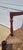 Find vintage country French bench in red paint. Featuring wide rush seat, turned carved stretcher, splayed arms, country...