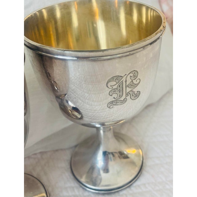 A set of 4 Derby S. P. Co. and International Co. silverplate drinking goblets with an old English “K” monogram. All...