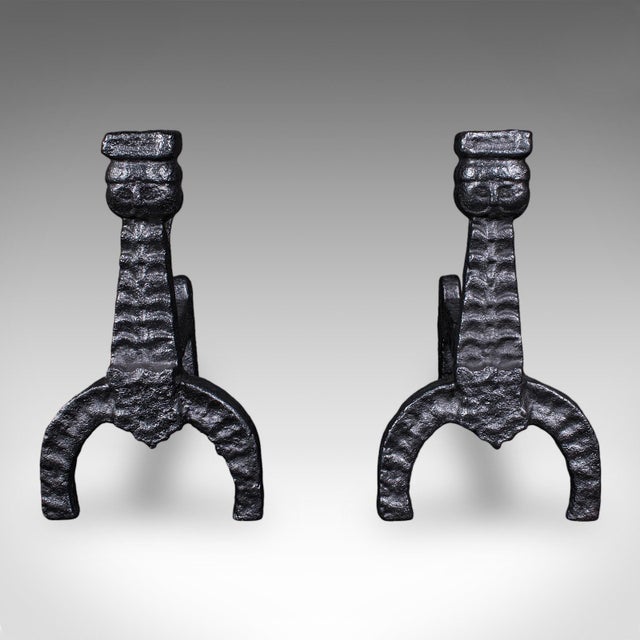 This is a pair of antique fireside andirons. An English, cast iron fire dog, dating to the Georgian period, circa 1805....