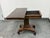 Design Plus Gallery presents a Victorian Regency Style Lift-Top Game Table. This antique table showcases a rectangular...