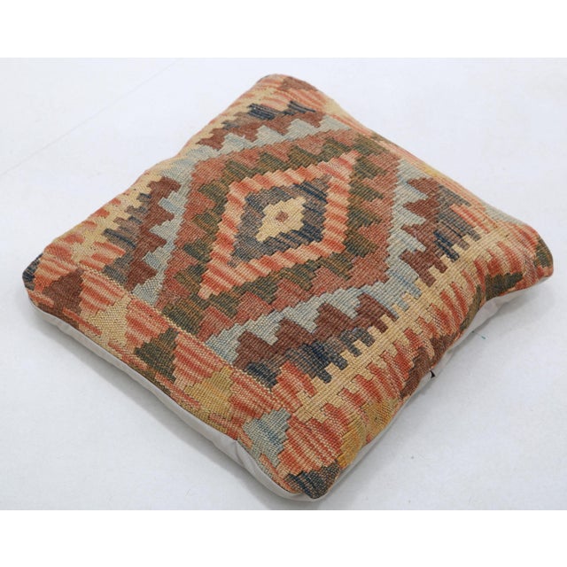 A one-of-a-kind handwoven Afghan wool kilim accent pillow featuring terracotta diamond medallion. Cut and sewn by hand...