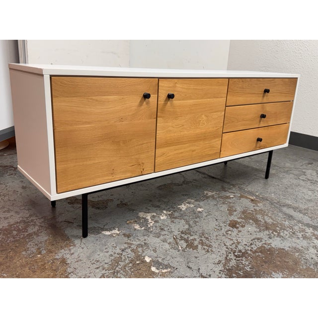 Design Plus Gallery presents a Bios Sideboard from Article. This contemporary storage piece pairs a white case with oak...
