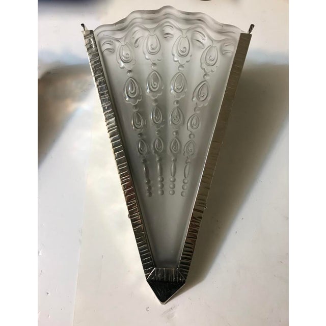 A pair of French Art Deco sconces by Genet ET Michon. Fan shaped design in clear frosted glass shades with Deco details...