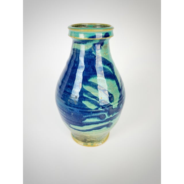 Bring handcrafted artistry into your home with this striking vintage hand-thrown studio pottery vase featuring layered...