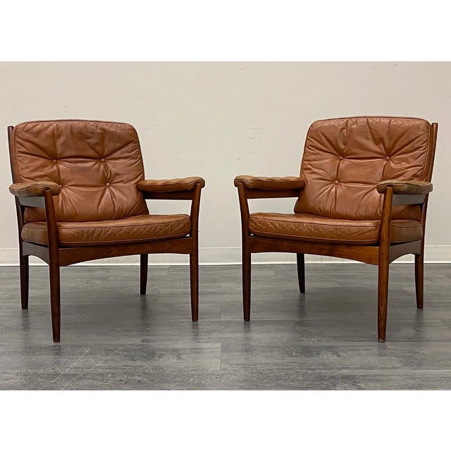 Teak frame and tufted leather upholstery. Marked to frame. Sweden, circa 1970s. Dimensions: H 32" x W 32" x D 27" x SH 16"...