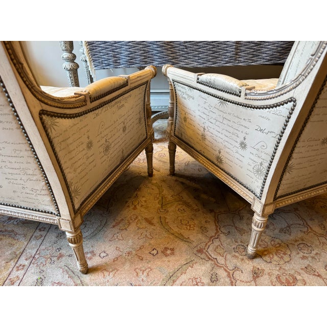 This is a pair of vintage French leather side chairs. They are Louis XVI style. They have studded detailing. They are...