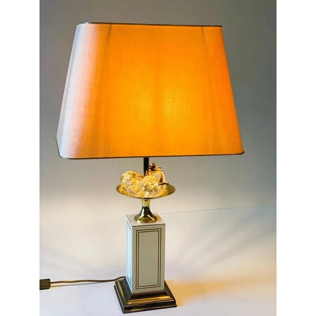 Hollywood Regency brass table lamp with crystal fruit, brass details on a beige lacquered rectangular base with a belgian...
