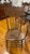 Highly stylish set of 8 antique oak American press back spindle chairs from the early 20th Century. The set is comprised...