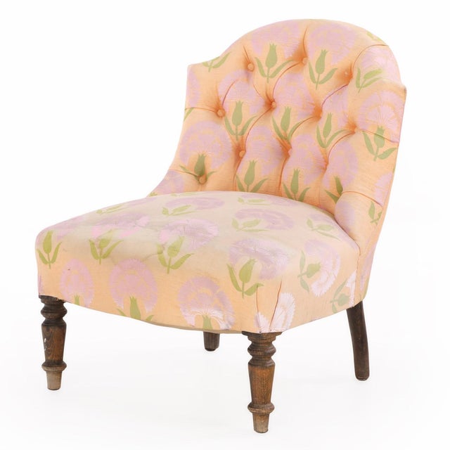 Each chair features a gracefully curved, low armless form with gently rounded backs and deep seats, characteristic of...