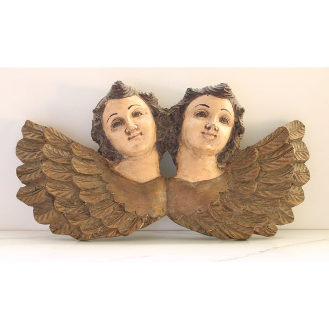 Crafted in Italy, circa 1760 a rare hand carved joined pair of winged putti/cherub's. Their wonderful polychromed and hand...