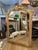 A large antique Louis XVI style Gold Gilt over mantel or fireplace mirror. Warm aged gilt, with some red bole showing. The...