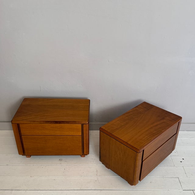 This elegant pair of Mid-Century bedside tables, crafted in walnut in Italy during the 1960s, showcases the refined...