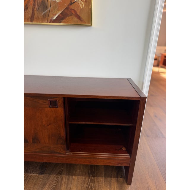 An exceptionally preserved 1960s Danish Modern rosewood credenza, distinguished by beautifully figured cabinetry, superb...
