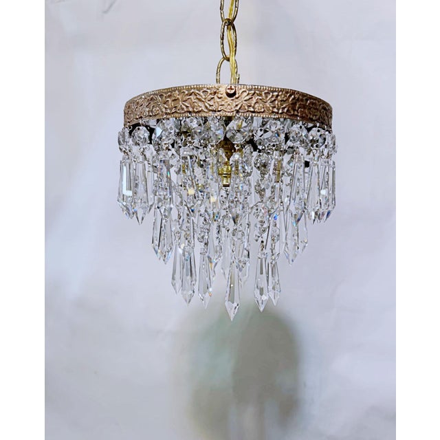 This exceptional mid-century chandelier is an absolute jewel box of light, capturing the dramatic, high-glamour aesthetic...