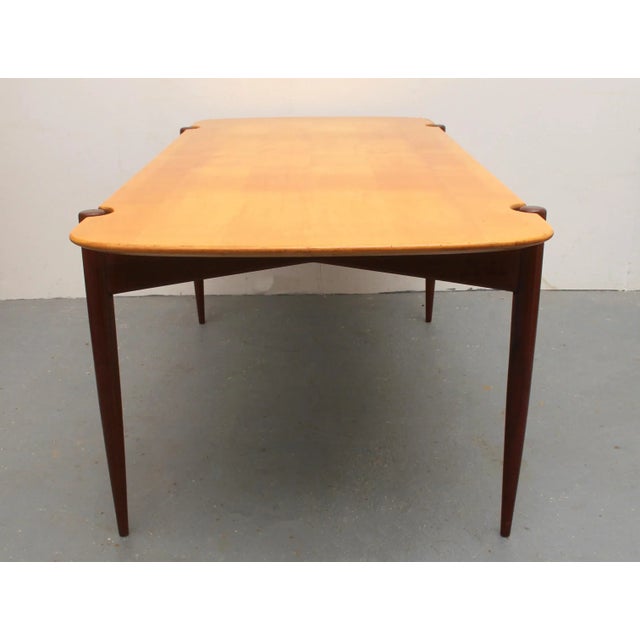Elegant 50s coffee table from Denmark. Beautifully shaped base in solid teak. Table top in light maple. With minor signs...