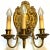 Each of these, antique three-light sconces has a cast bronze wall plate that features a central shell surmounted by a...