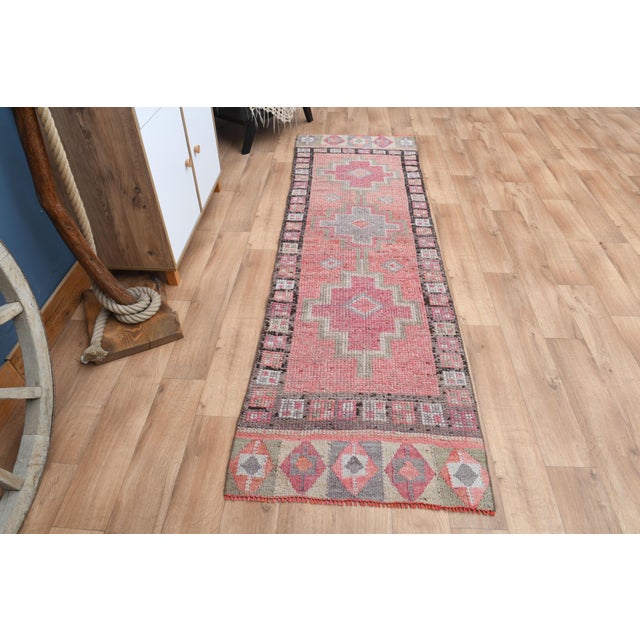 Vintage Turkish Hand-Knotted vintage rug is a semi-antique vintage runner rug. The '70s Eastern region of Turkey's unique...