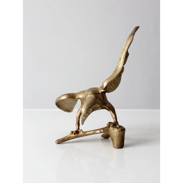 This vintage solid brass eagle sculpture features intricate details and a stunning design. Its heavy build and aged patina...