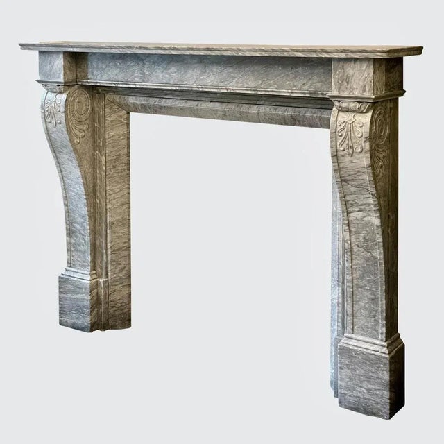 A well drawn and superb quality english regency fireplace in italian bardiglio marble. The paneled console jambs with...
