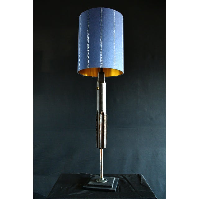 A retired giant machine tap made into a table lamp. All the teeth are worn and pose no threat to touch. An industrial...