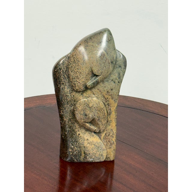 Design Plus Gallery presents an African Hand-Carved Stone Mother and Child Sculpture. This carved stone sculpture depicts...