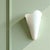 Minimalist wall sconce made in Italy. Made of white glass and with a metal fixing plate. Equipped with one E27 light bulb...