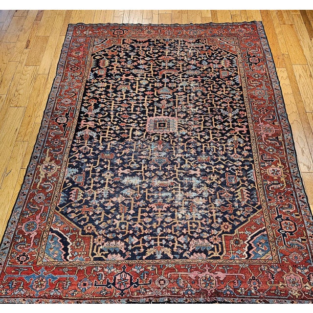 "A truly exceptional and rare find, this late 19th-century Persian Heriz Serapi rug showcases an uncommon and highly...