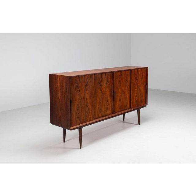 Gunni Omann Model 19 highboard in Santos rosewood, produced by Omann Jun. Denmark 1960s. An impressive Danish highboard...
