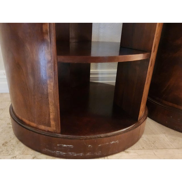 Set of two beautiful Baker Round Mahogany Book Tables. Banded with inlaid details. Two sheles. Good condition with minor...